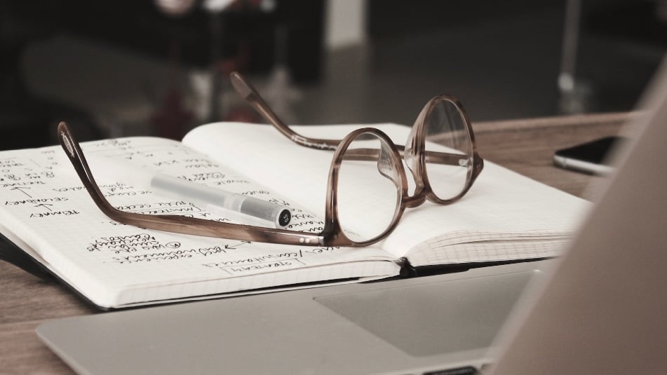 Spectacles on top of a notebook