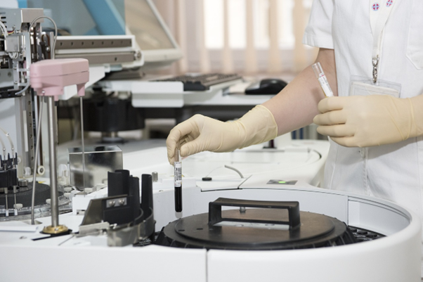 Lab technician working with laboratory equipment.