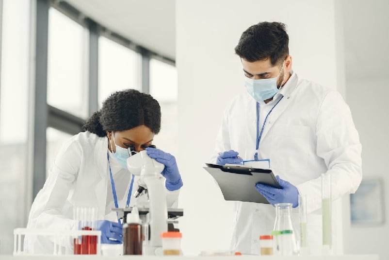 Man and woman in white coats in the laboratory