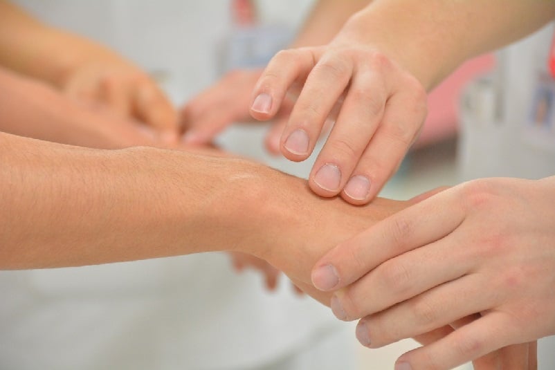 Hands checking for symptoms in patients hands